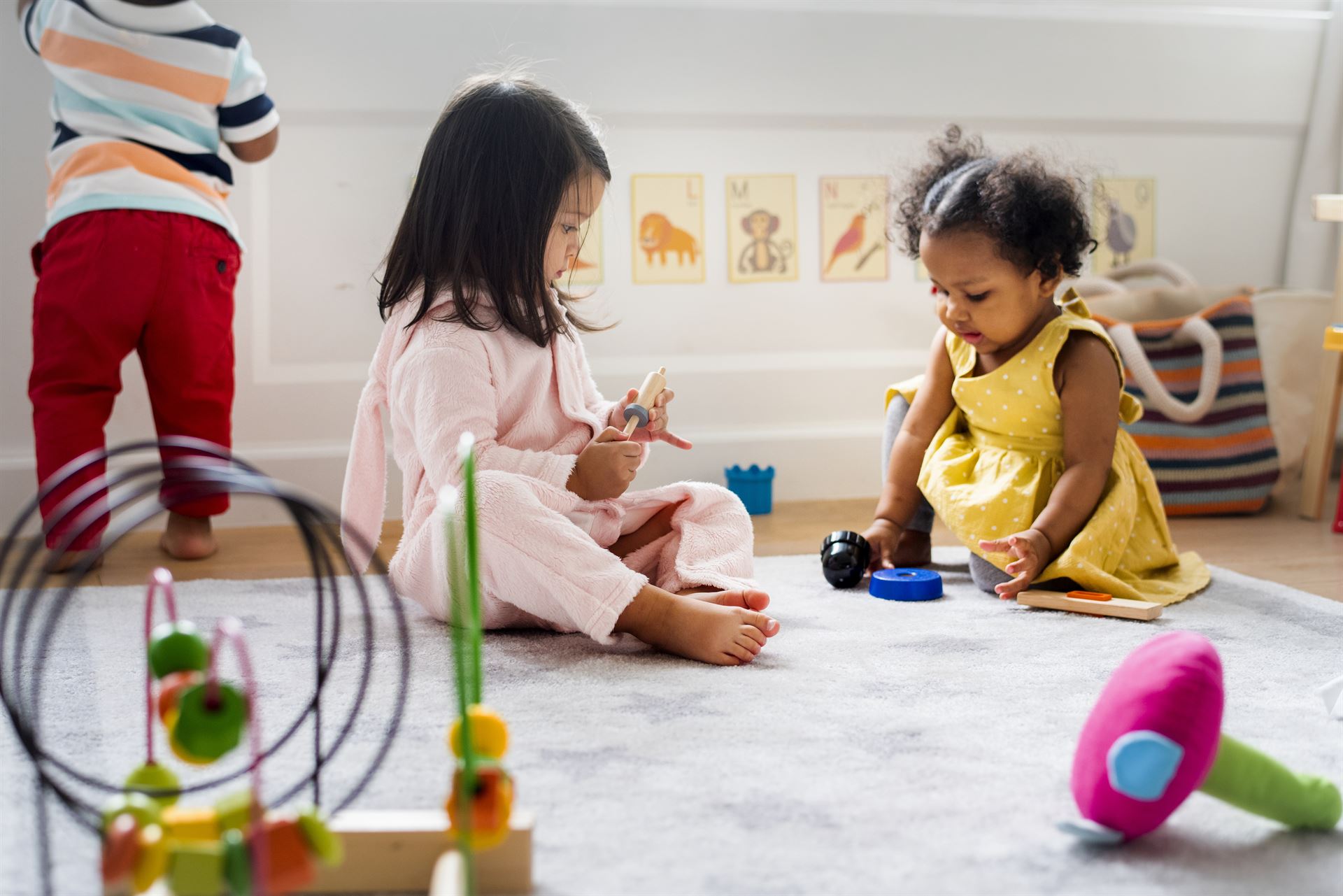 Little kids playing toys in the playroom photo-1